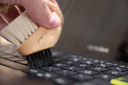 keyboard brush made of FSC wood and natural bristles on marble background
 