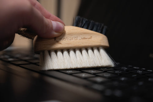 keyboard brush made of FSC wood and natural bristles on marble background
 