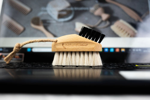 keyboard brush made of FSC wood and natural bristles on marble background
 
