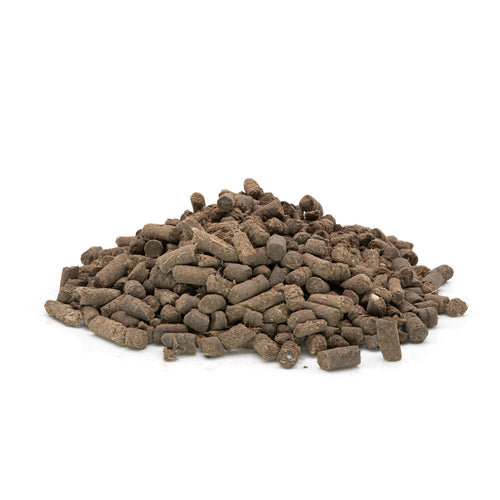 Pile of natural sheep wool pellets on a white background. 