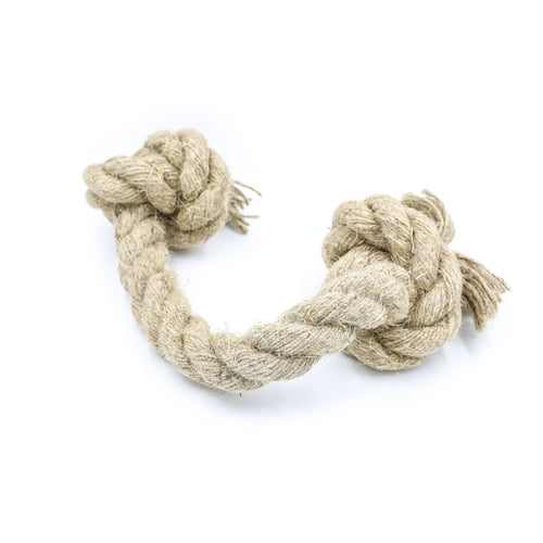 A small natural jute hemp knotted rope toy sits upon a white background. This natural knotted dog toy has two knots and this is the smaller size.