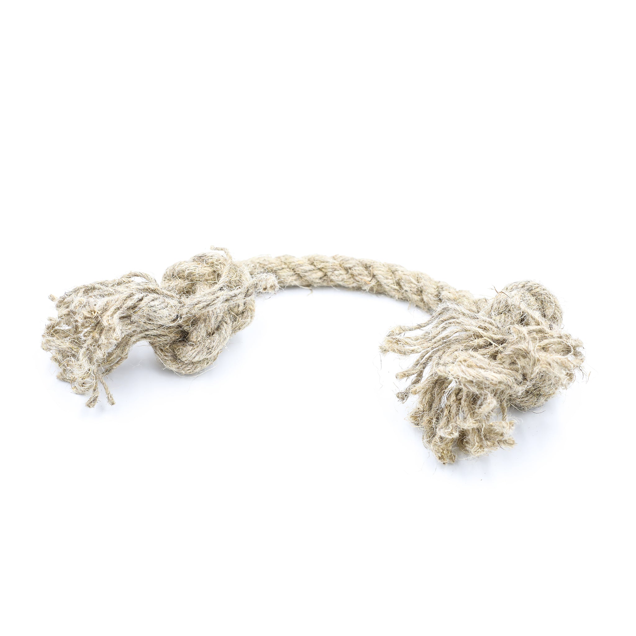 A small natural jute hemp knotted rope toy sits upon a white background. This natural knotted dog toy has two knots and this is the smaller size. The toy is laid lightly curved across the white space