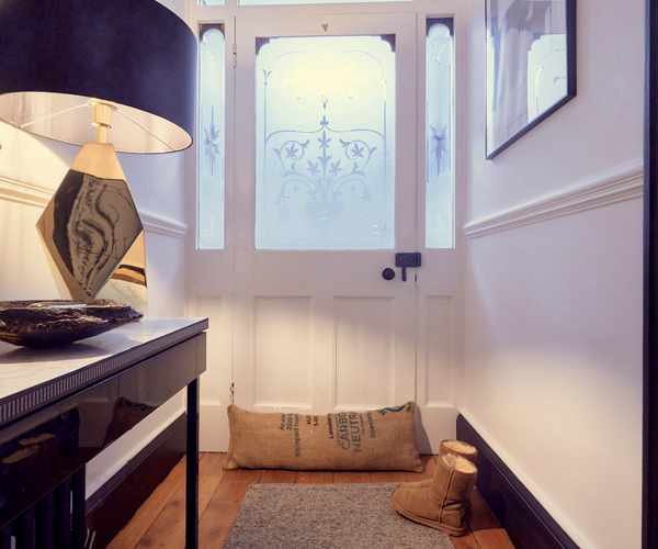 Door draught excluder and wool rug in the hallway of a Victorian house