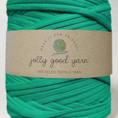 Red yarn ball with a beige label on a white background