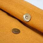 Close-up of brass press studs on luxury organic cotton and sheep wool dog bed