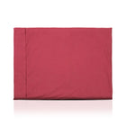 Red luxury dog bed made of organic fabric filled with sheep wool felt on a white background