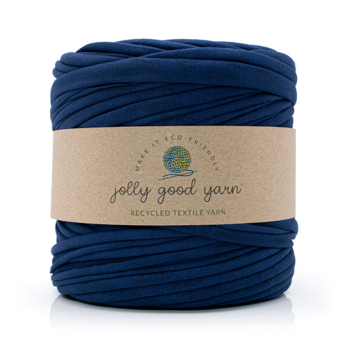 A skein of deep blue recycled textile yarn wrapped in a brown kraft paper label that reads 'jolly good yarn'.