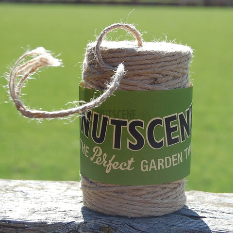 A spool of jute twine placed on a table, wrapped in a green label
