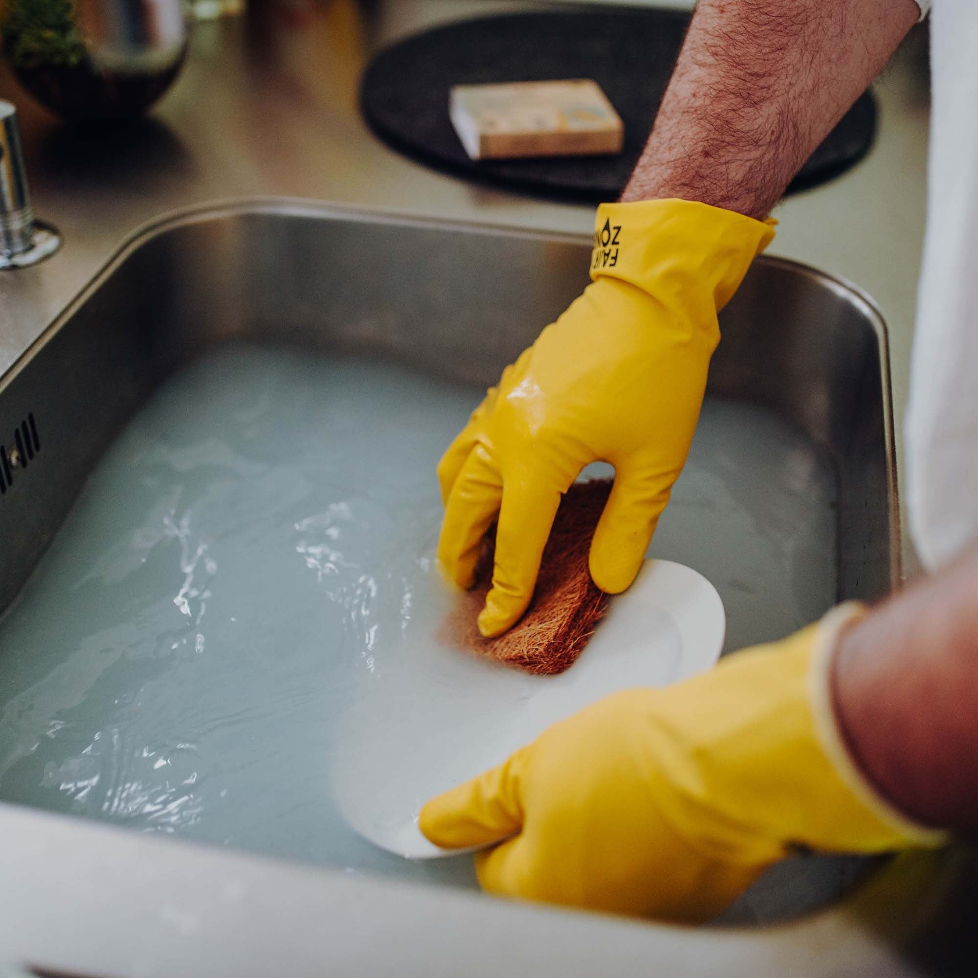 FSC Certified Fair Trade Rubber Gloves doing the washing up. 
