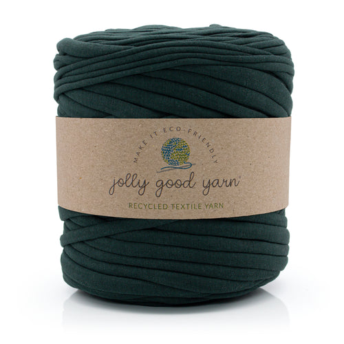 A skein of deep blue recycled textile yarn wrapped in a brown kraft paper label that reads 'jolly good yarn'.