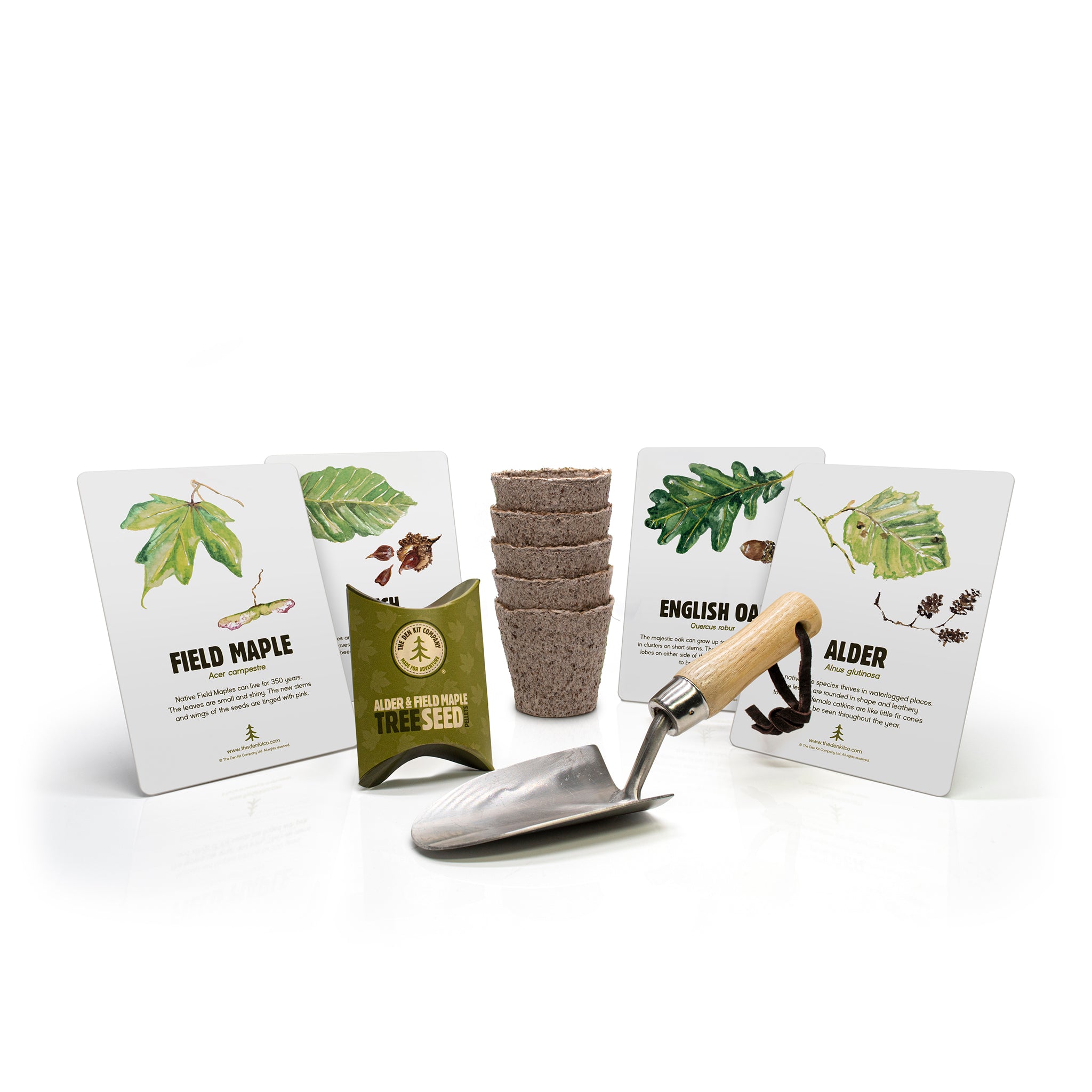 Contents of the plant a tree kit up against a white background, including tree identification cards, ash wooden handled trowel and tree seeds.