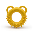 Yellow Fairtrade rubber tug toy shaped like a spikey doughnut with ears for handles on a white background.
