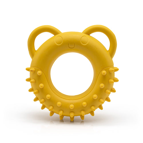 Yellow Fairtrade rubber tug toy shaped like a spikey doughnut with ears for handles on a white background.
