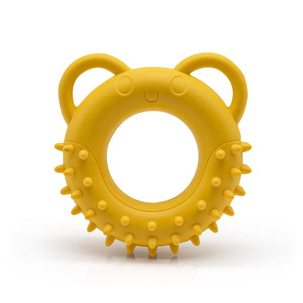 Yellow Fairtrade rubber tug toy shaped like a spikey doughnut with ears for handles on a white background.
