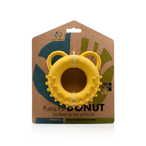 Yellow Fairtrade rubber tug toy shaped like a spikey doughnut with ears for handles on a white background.
