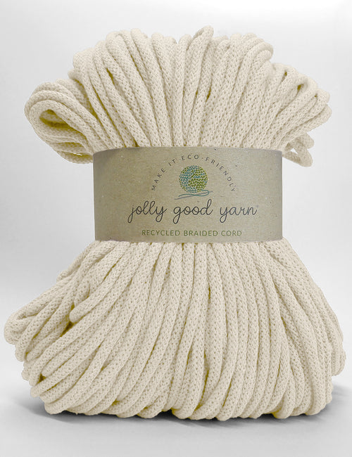 A skein of Jolly Good Yarn recycled braided cord in a vibrant orange color, wrapped in a brown paper label, on a clean white background.