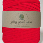 Red ball of yarn with a 'jolly good yarn' label on a white background
