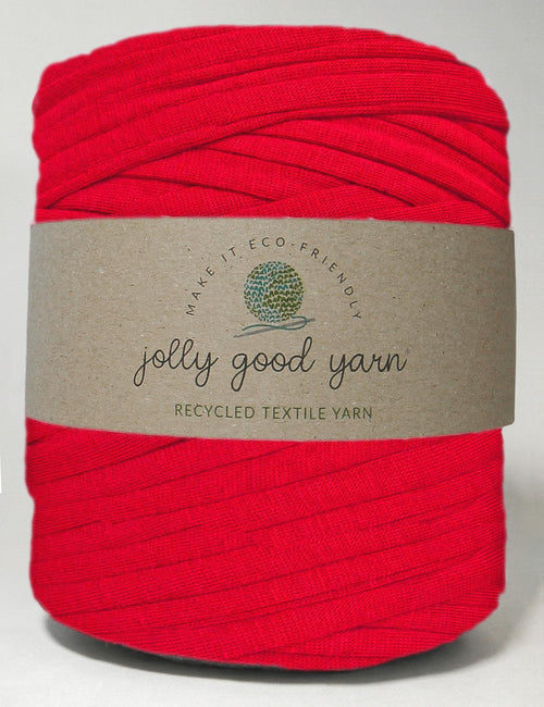 Red yarn ball with a beige label on a white background