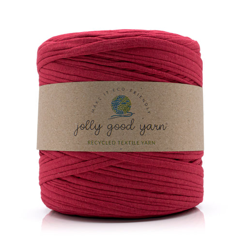 A skein of deep blue recycled textile yarn wrapped in a brown kraft paper label that reads 'jolly good yarn'.