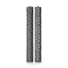 Two grey fabric rolls standing upright on a white background, one with a black flower pattern and the other with a white flower pattern.