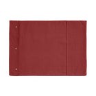 A Chimney Sheep wool filled portable rollup travel dog bed sits on a white background. This flat rectangular portable roll up dog bed is in the colour red. You can see the white poppers which allow it to be simply rolled into a tight package for easy transportation.