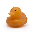 Natural latex rubber yellowish coloured duck with a pensive smile on a white background
