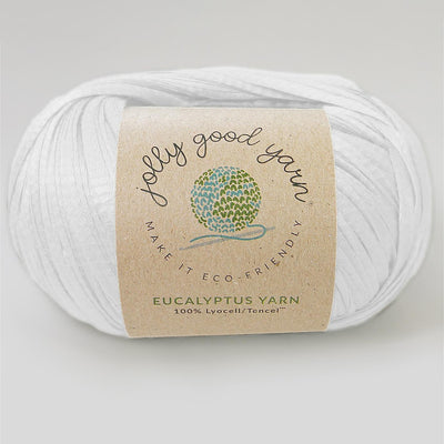 Yellow yarn ball with a label on a light gray background