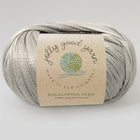 Ball of grey soft and sustainable yarn on a gray background