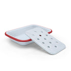 White soap dish with red rim on a white background