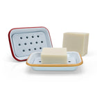 Two soap dishes with bars of soap on a white background