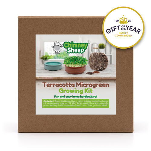 terracotta microgreen grower growing cress on a wooden surface, with a 'Gift of the Year' award badge in the corner.