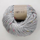 Gray yarn ball with colorful speckles on a white background