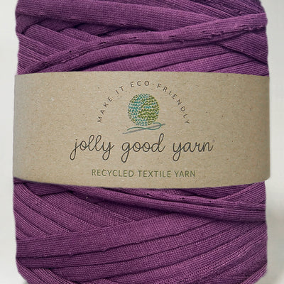 Red yarn ball with a beige label on a white background