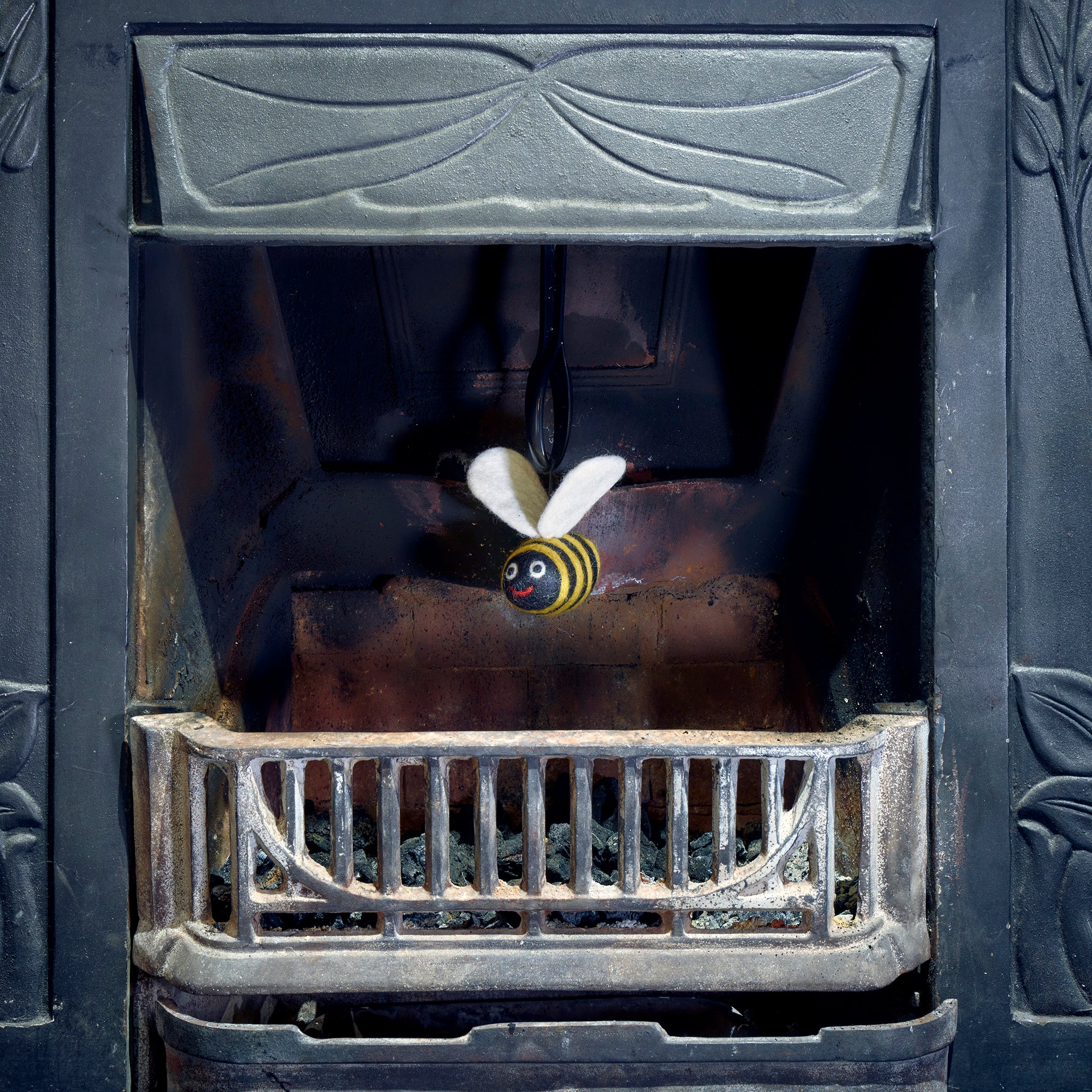 woolly felted bee dangle in fireplace
