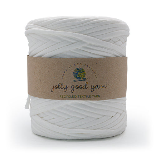 A skein of deep blue recycled textile yarn wrapped in a brown kraft paper label that reads 'jolly good yarn'.