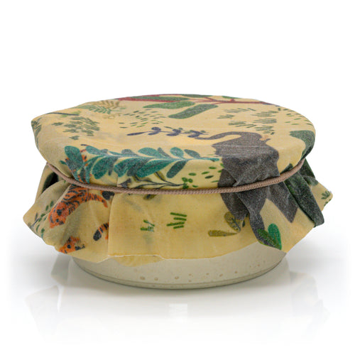 Wild Beeswax Wraps by Chimney Sheep, featuring a brown kraft paper box and three reusable beeswax wraps with colorful botanical and animal patterns on a white background