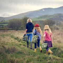 woman and children walking with eco chic bags thumbnail