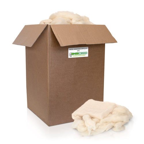 Pile of offcuts from wool wadding on a white background 