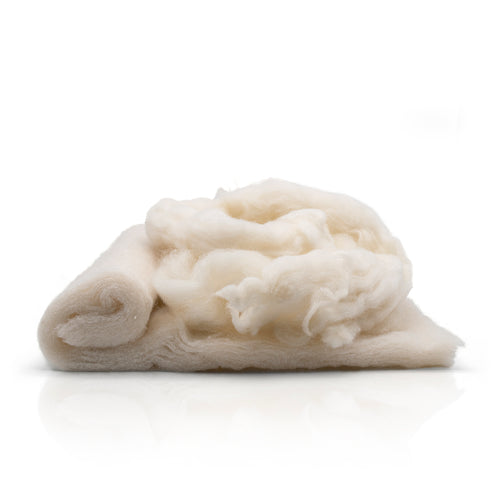 Pile of offcuts from wool wadding on a white background 