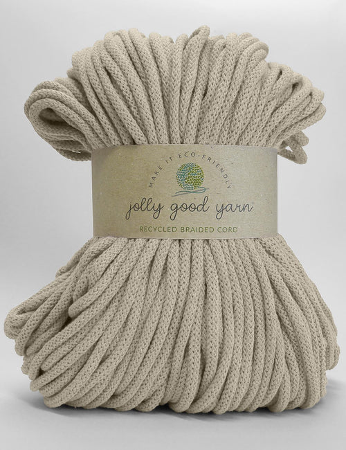 A skein of Jolly Good Yarn recycled braided cord in a vibrant orange color, wrapped in a brown paper label, on a clean white background.