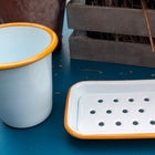 white enamel soap dish and cup with mustard yellow rim