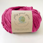 Pink yarn ball with a label on a white background