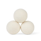 3 White Wool Dryer Balls laid out on a white background 