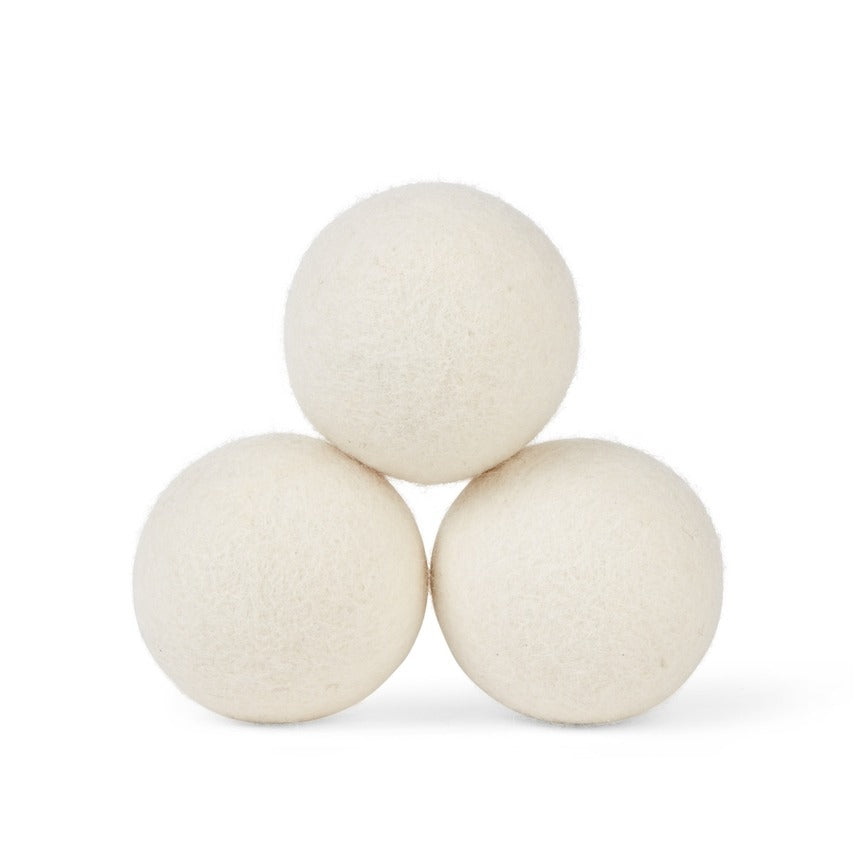 3 White Wool Dryer Balls laid out on a white background 