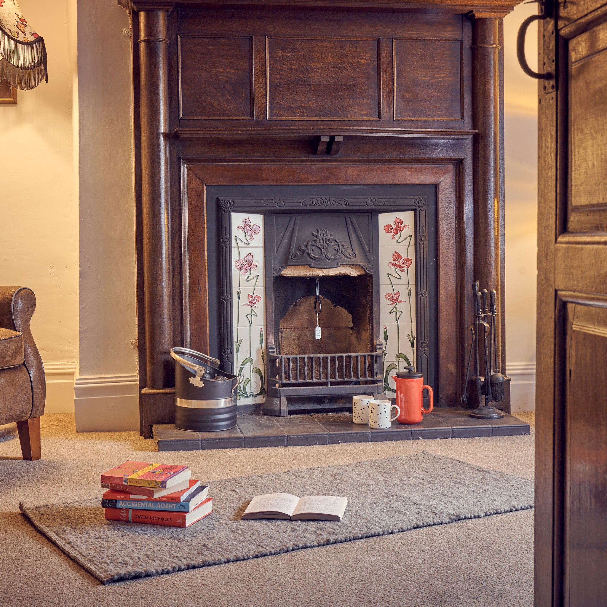 A fireplace with a chimney draught excluder inserted into the chimney flue