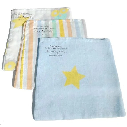 3 folded organic cotton muslins with different designs