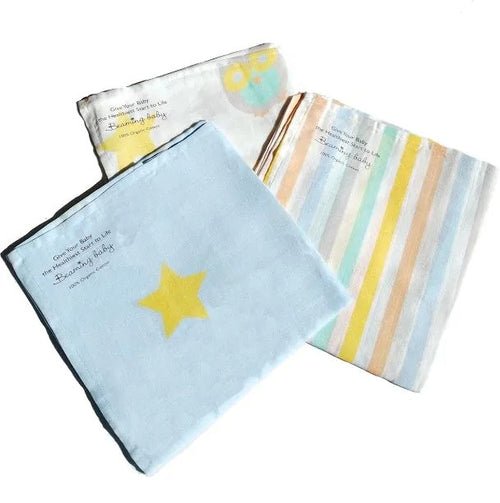 3 folded organic cotton muslins with different designs