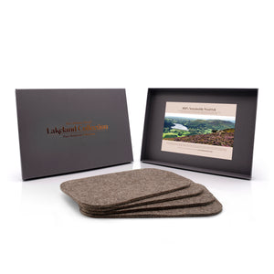 The lakeland collection, pack of four luxury grey sheep's wool tablemats. Both grey box and tablemats are placed on a white background