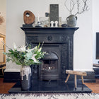 Chimney draught excluder inserted into a chimney flue with handle and safety tag on show.