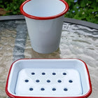 white enamel soap dish and mug with red rim